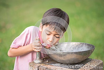 Little boy drinking public water Stock Photo
