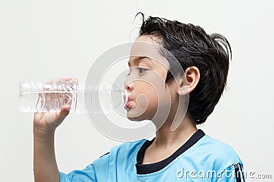 Little boy drinks water from a bottle after excercise Stock Photo