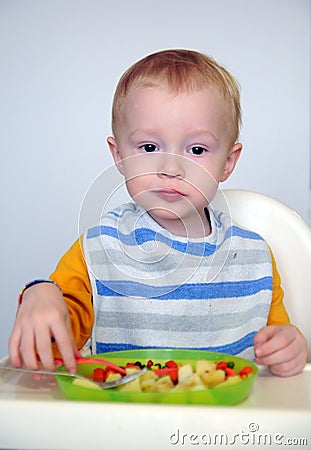 The little boy is eating his food Stock Photo