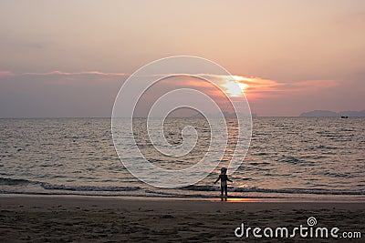 A little boy is enjoying the last sun beams on the beach Editorial Stock Photo