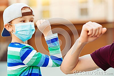 Little boy and father greeting with elbows outdoors. Coronavirus prevention. Elbow greeting style. Family, lifestyle, new style of Stock Photo