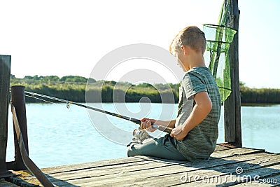 Little boy fishing alone on sunny day. Stock Photo