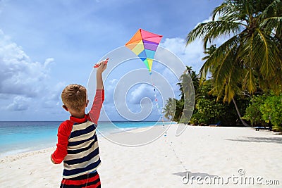 Little boy flying a kite on tropical beach Stock Photo