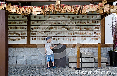 Little boy in front of an area with ema Editorial Stock Photo