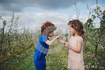 Little boy and girl in blooming garden Stock Photo