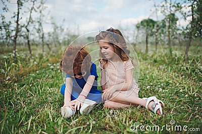 Little boy and girl in blooming garden Stock Photo