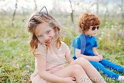 Little boy and girl in blooming garden Stock Photo