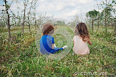 Little boy and girl in blooming garden Stock Photo