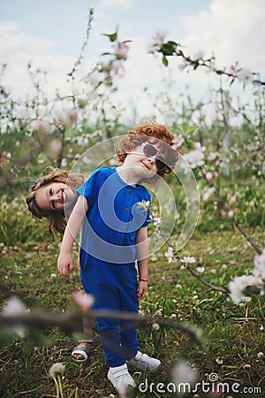 Little boy and girl in blooming garden Stock Photo