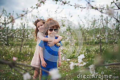 Little boy and girl in blooming garden Stock Photo