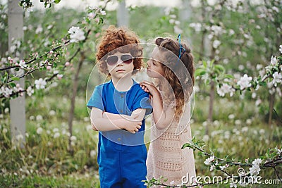 Little boy and girl in blooming garden Stock Photo