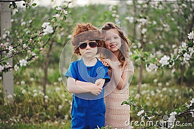 Little boy and girl in blooming garden Stock Photo