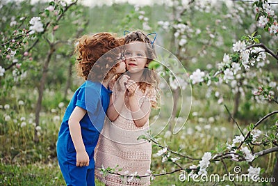 Little boy and girl in blooming garden Stock Photo