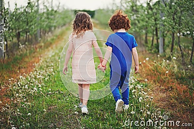 Little boy and girl in blooming garden Stock Photo