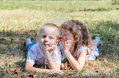 Little boy and the girl lie together on a grass Stock Photo