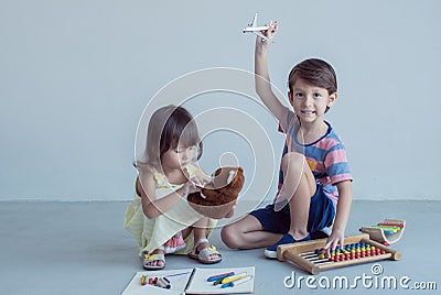 Little boy and girl playing together at school Stock Photo