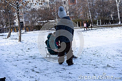 Little boy and girl sledding Editorial Stock Photo