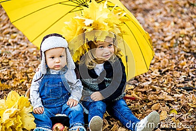 Little boy with a girl under an umbrella from the rain autumn Stock Photo