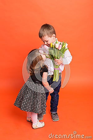 Little boy gives a girl a bouquet of flowers Stock Photo