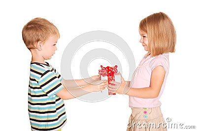 Little boy giving a little girl a gift. Stock Photo