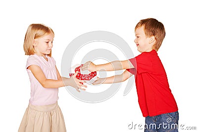 Little boy giving a little girl a gift. Stock Photo