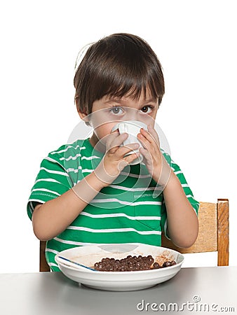 Little boy has his breakfast at the table Stock Photo