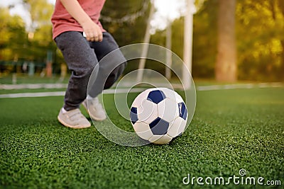 Little boy having fun playing a soccer/football game on summer day. Active outdoors game/sport for children Stock Photo