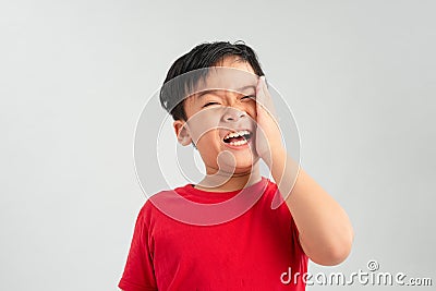 Little boy having toothache. Emotional portrait of asian boy suffering. Sad child with tooth pain. Dental problem Stock Photo