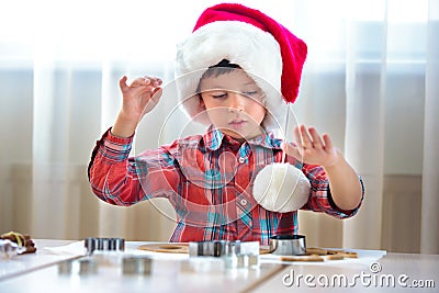 Little boy helping at kitchen with baking cookies Editorial Stock Photo