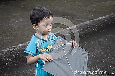 A little boy hold a kite in his hand. Editorial Stock Photo