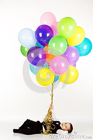 Little boy holding colorful balloons Stock Photo