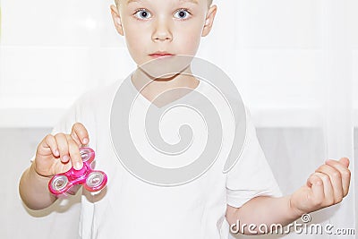Little boy holding fidget spinner in hand closeup. Stock Photo