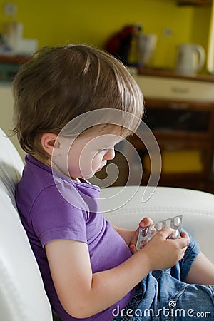 Little boy holding pills Stock Photo