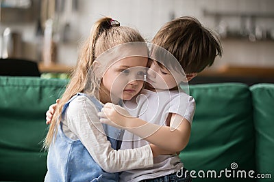 Little boy brother consoling and supporting upset girl embracing Stock Photo