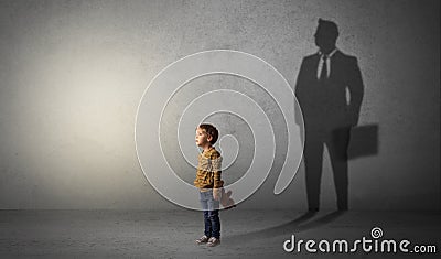 Little boy with businessman shadow Stock Photo