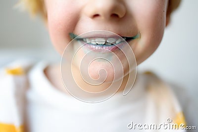 Little boy is learning carefully brush teeth. Child using liquid for disclosing plaque. Teaching children proper oral hygiene. Stock Photo
