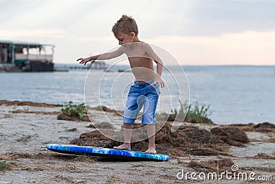 Little boy learning how to surf Stock Photo