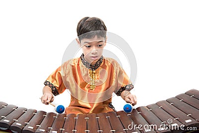 Little boy learning Thai instument Xylophone, Ranat, on white background Stock Photo