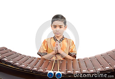 Little boy learning Thai instument Xylophone, Ranat, on white background Stock Photo