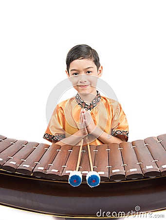 Little boy learning Thai instument Xylophone, Ranat, on white background Stock Photo