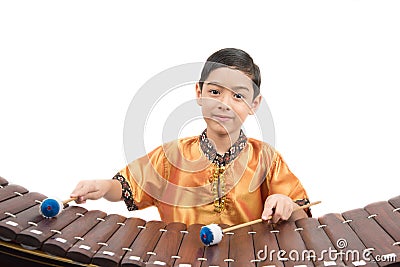 Little boy learning Thai instument Xylophone, Ranat, on white background Stock Photo