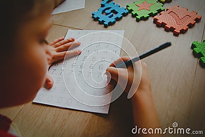 Little boy learning write and culculate numbers Stock Photo