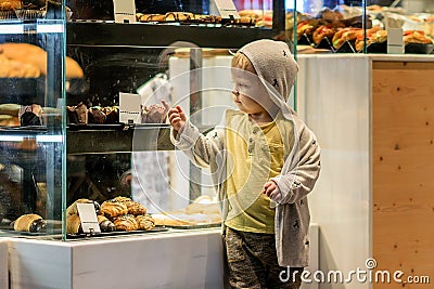 Little boy is looking at the buns. Stock Photo