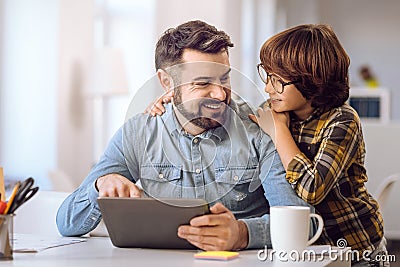 Little boy looking very happily on his father Stock Photo