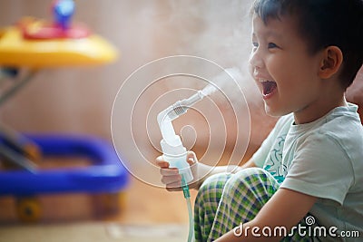 Little boy makes inhalation at home, taking medication to bronchial tubes. Stock Photo