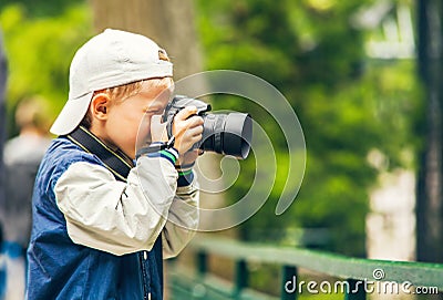 Little boy with photo camera makes a shoot Stock Photo