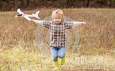 Little boy with plane. Little kid dreams of being a pilot. Child playing with toy airplane. Happy child playing Stock Photo