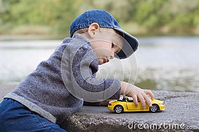 Little boy play with a car Stock Photo