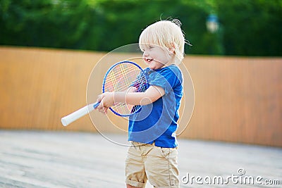 Little boy playing badminton with mom on the playground Stock Photo