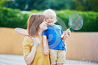 Little boy playing badminton with mom on the playground Stock Photo